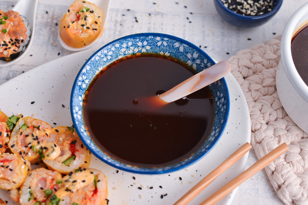 angled shot of spoon in bowl of eel sauce