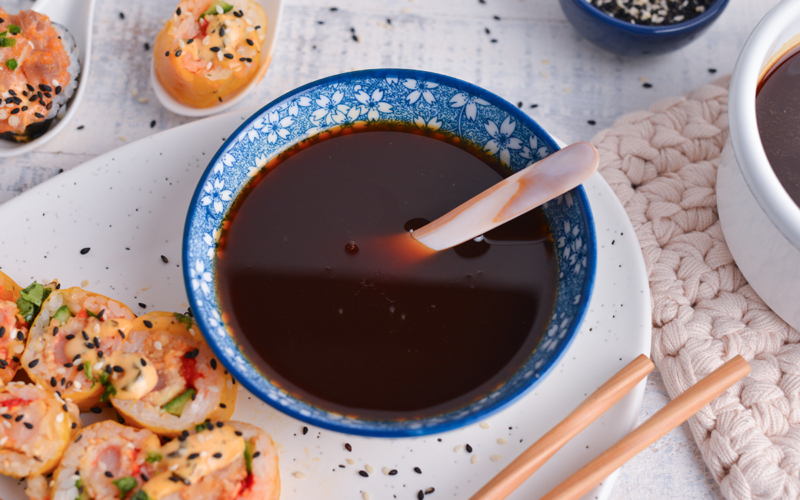 angled shot of spoon in bowl of eel sauce