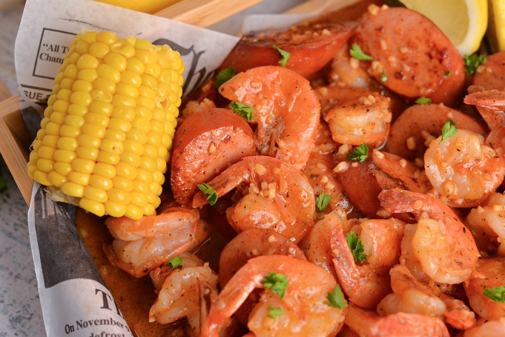 cob of corn in shrimp bowl using the boiling crab recipe 