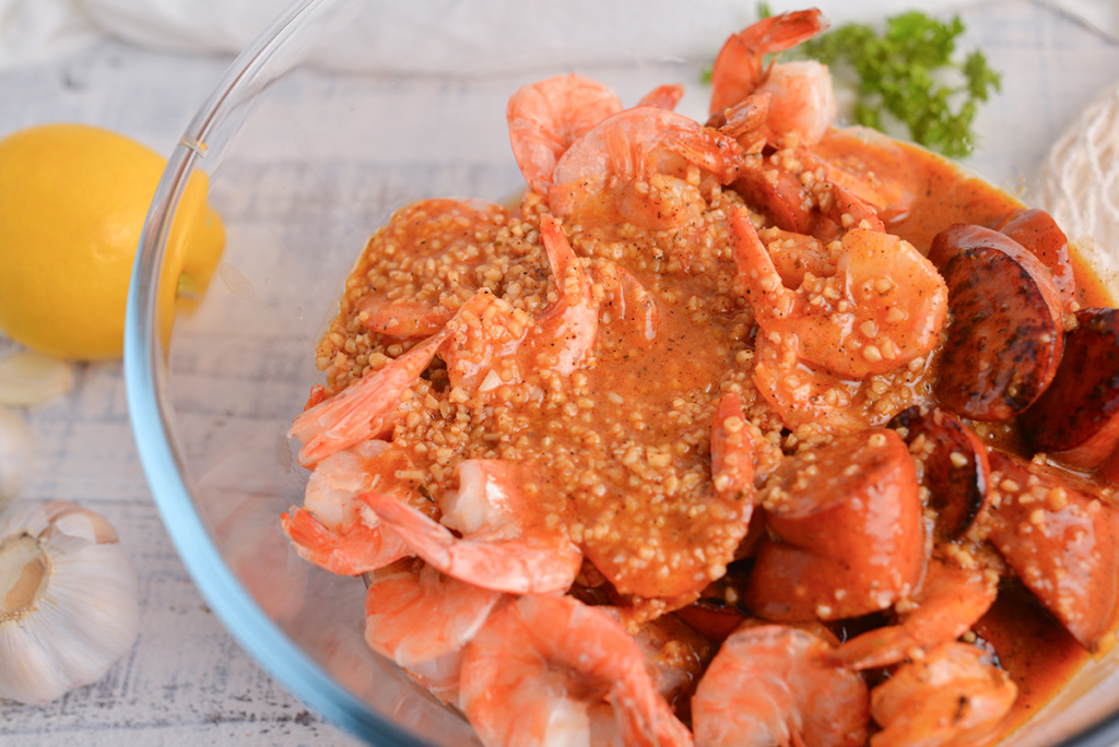 boiling crab sauce on bowl of shrimp