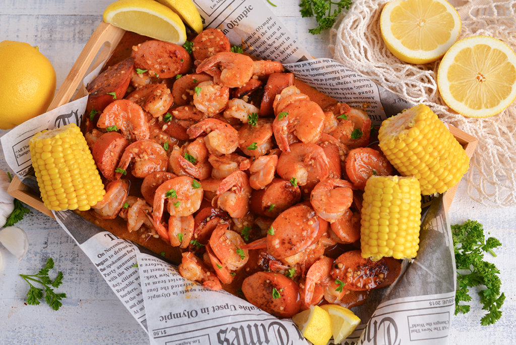 overhead shot of shrimp boil topped with boiling crab sauce