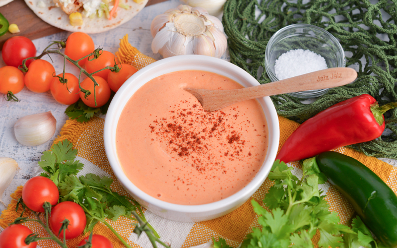 angled shot of bowl of chipotle sauce with spoon in it