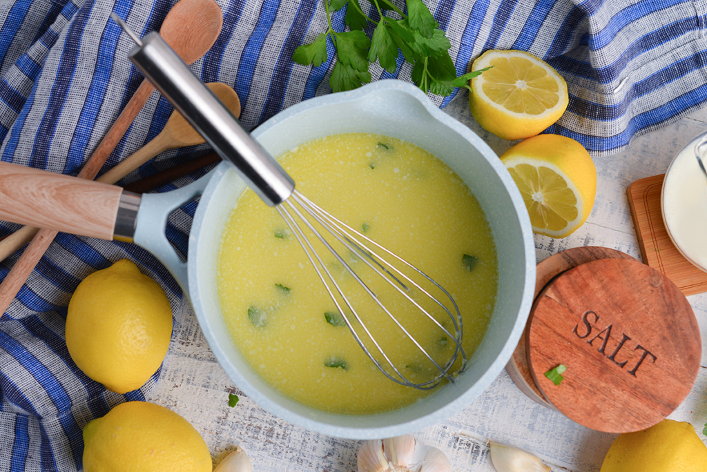 lemon butter sauce for pasta in saucepan with whisk