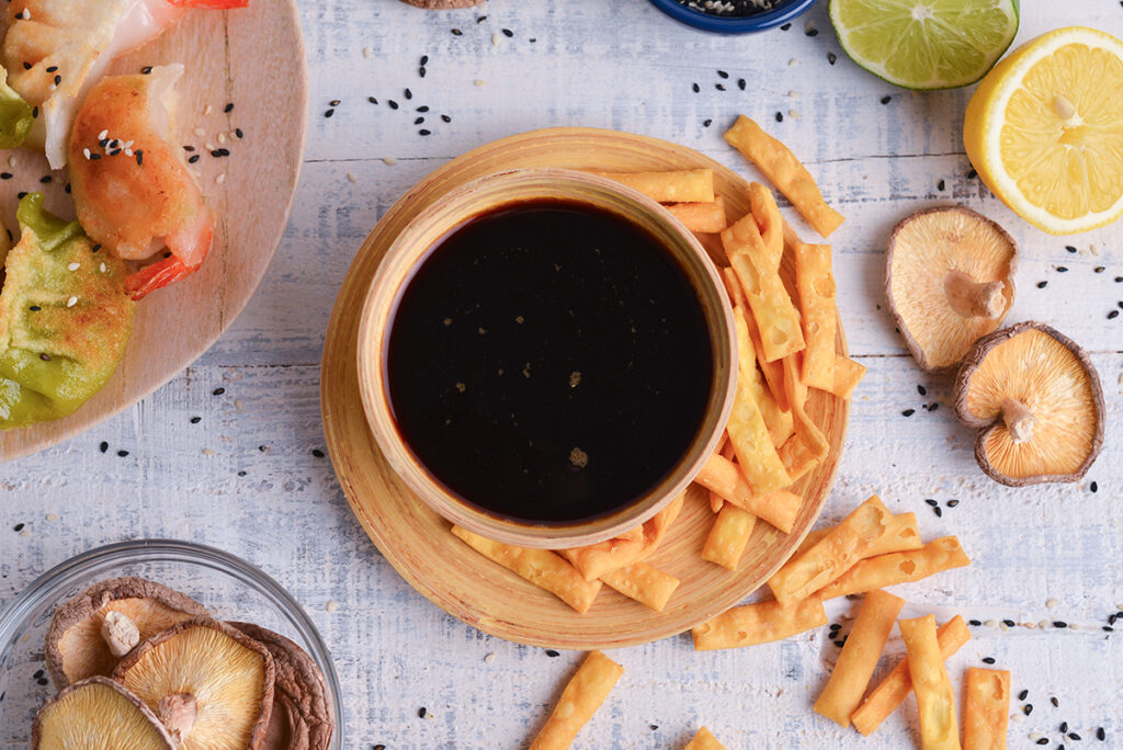 close up overhead shot of bowl of 
a recipe for ponzu sauce with wonton strips