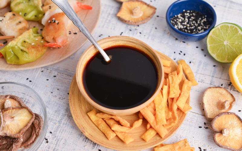 angled shot of spoon in bowl of ponzu sauce