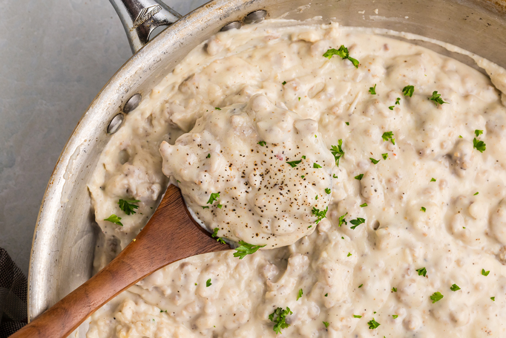 overhead shot of wooden spoon in pan of country gravy