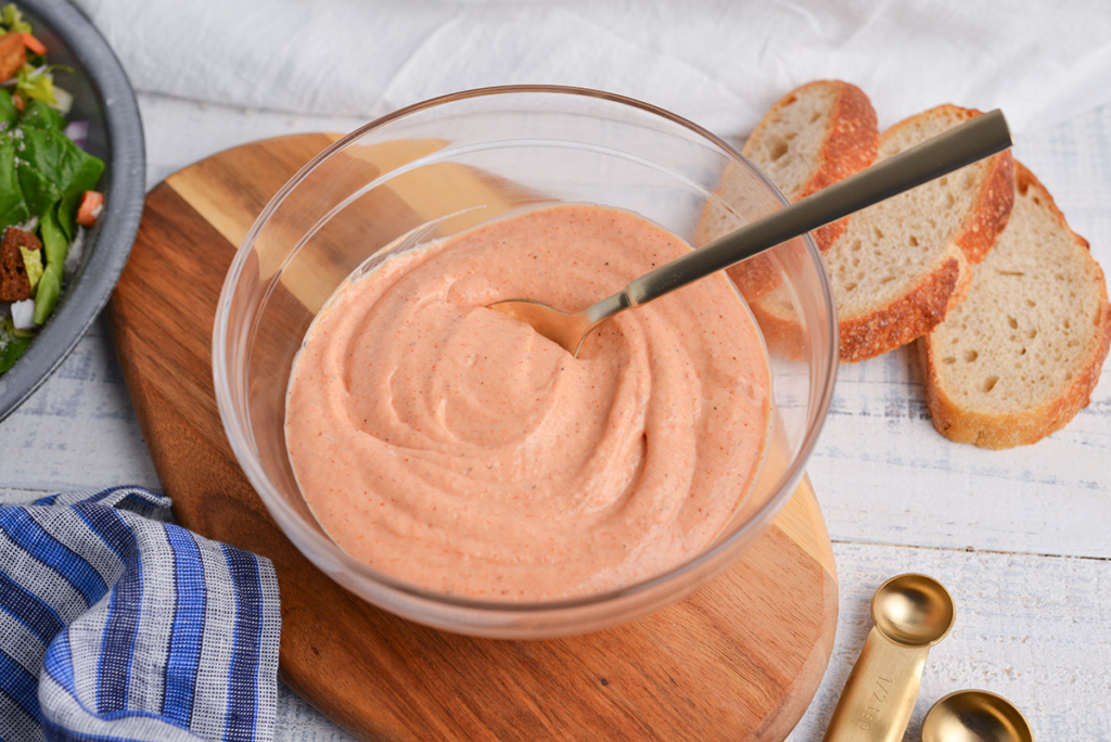 angled shot of russian dressing in bowl with spoon