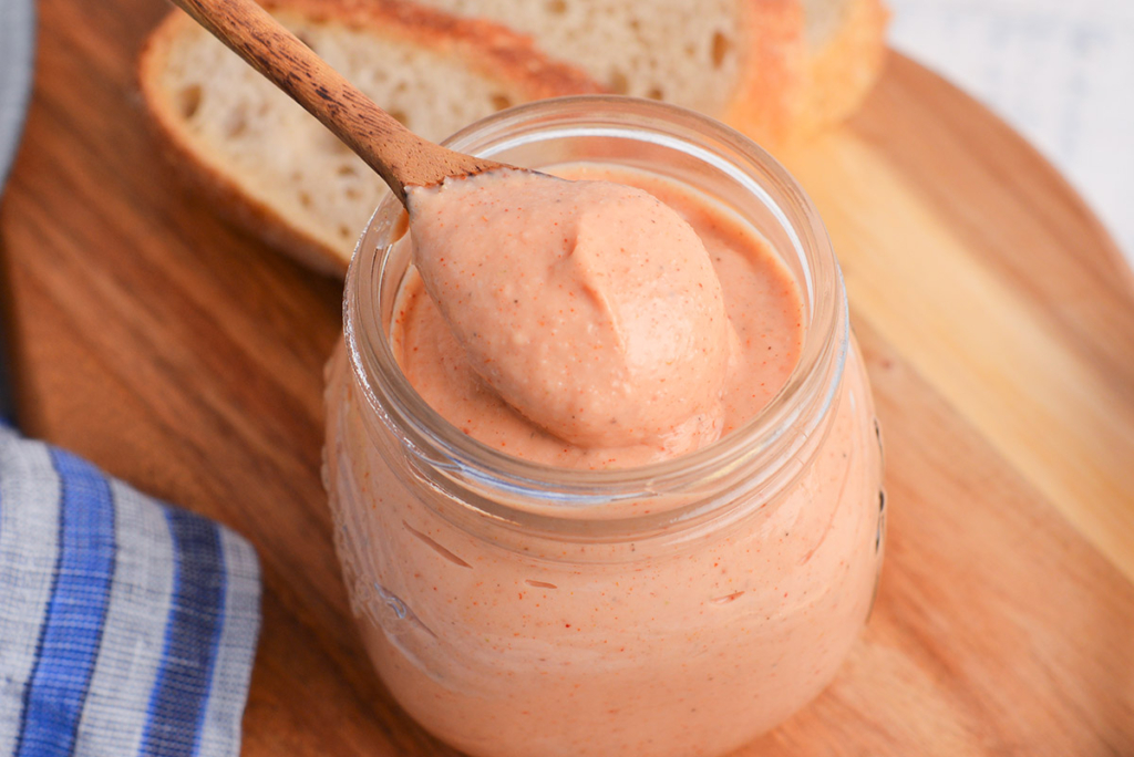 close up angled shot of spoon in jar of russian dressing