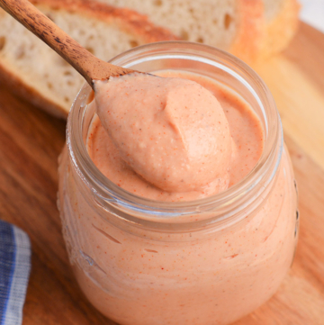 close up angled shot of spoon in jar of russian dressing