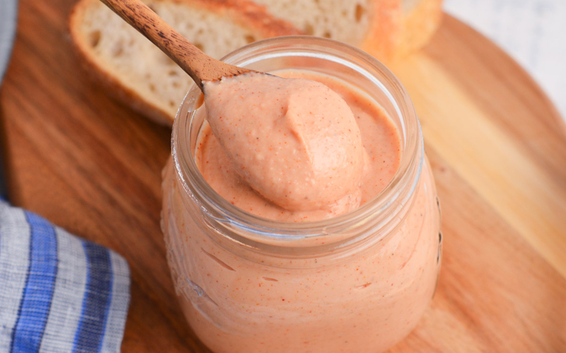 close up angled shot of spoon in jar of russian dressing