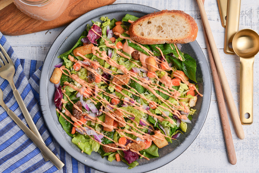 overhead shot of russian dressing drizzled over salad