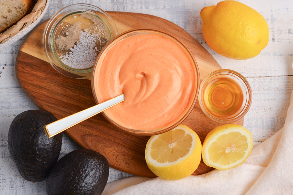 overhead shot of spoon in bowl of sriracha mayo