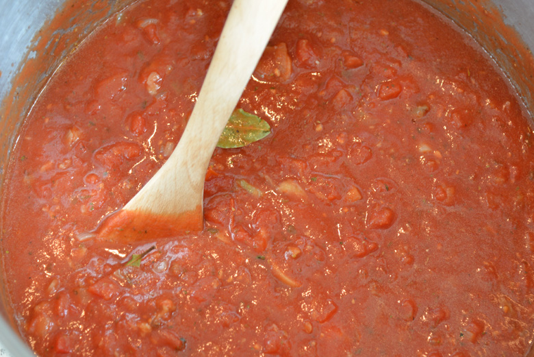 wooden spoon stirring sunday gravy