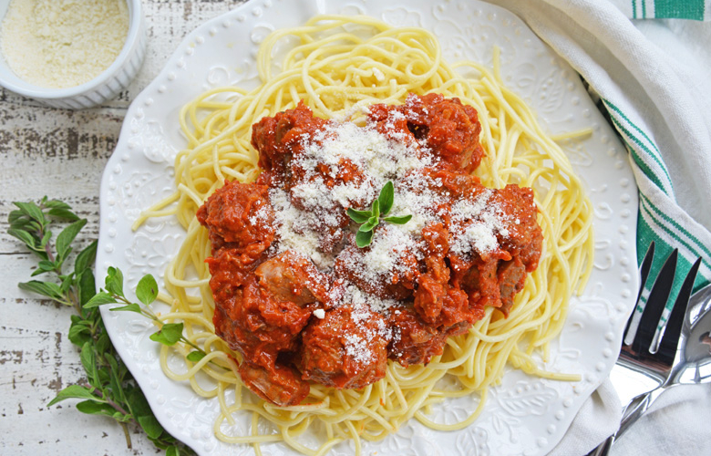 overhead shot of spaghetti sauce over pasta