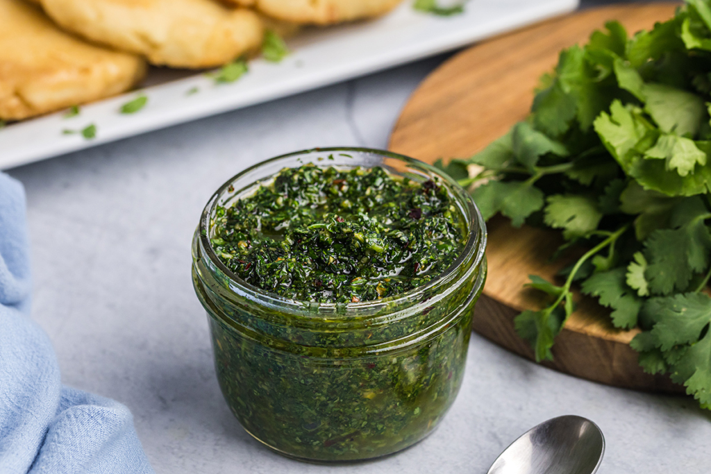 angled shot of jar of chimichurri sauce