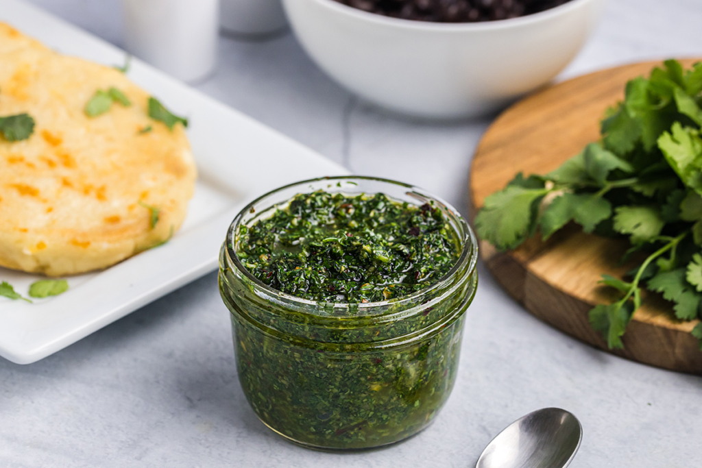 angled shot of jar of chimichurri sauce