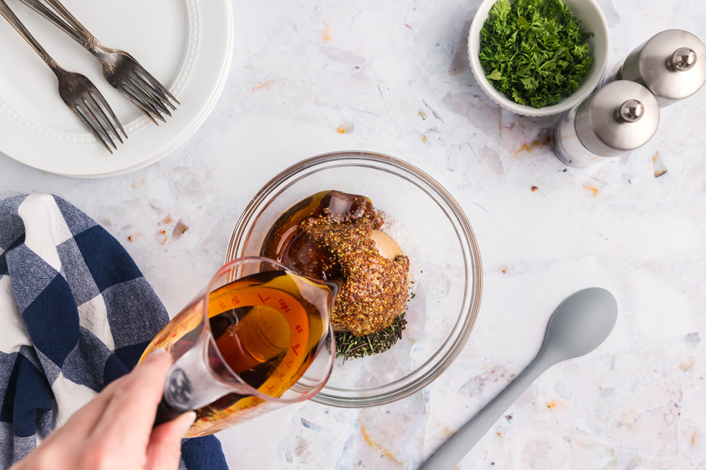 maple syrup poured into bowl of ham glaze ingredients