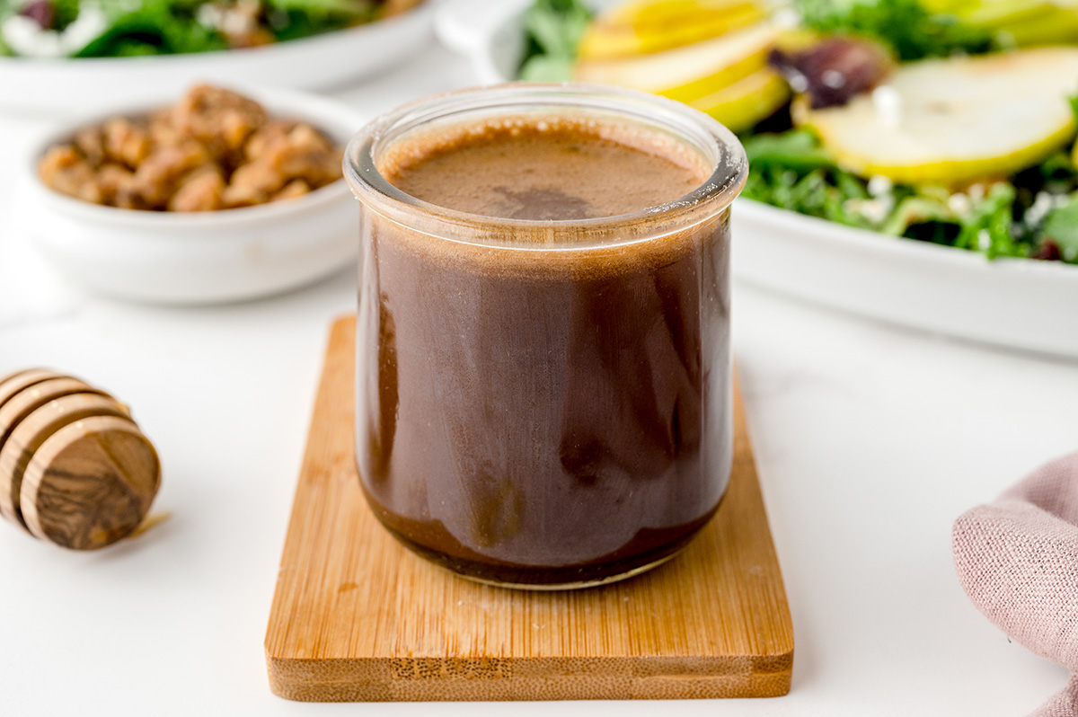 angled shot of jar of honey balsamic vinaigrette