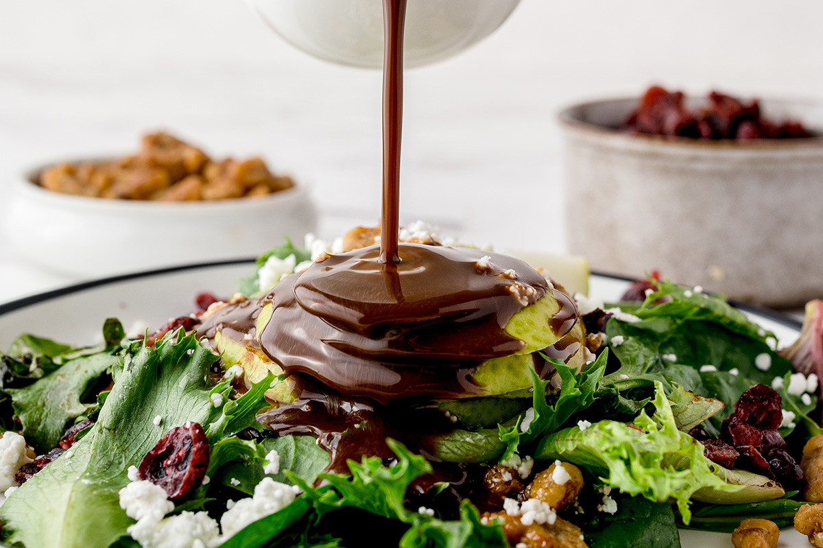 honey balsamic vinaigrette pouring over salad