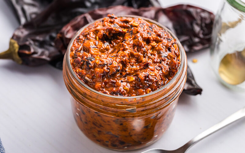 close up angled shot of jar of harissa sauce