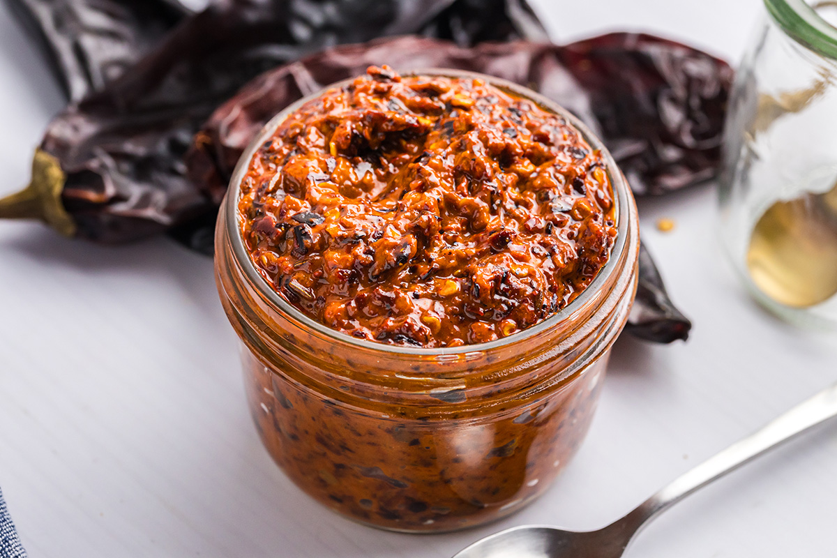 close up angled shot of jar of harissa sauce