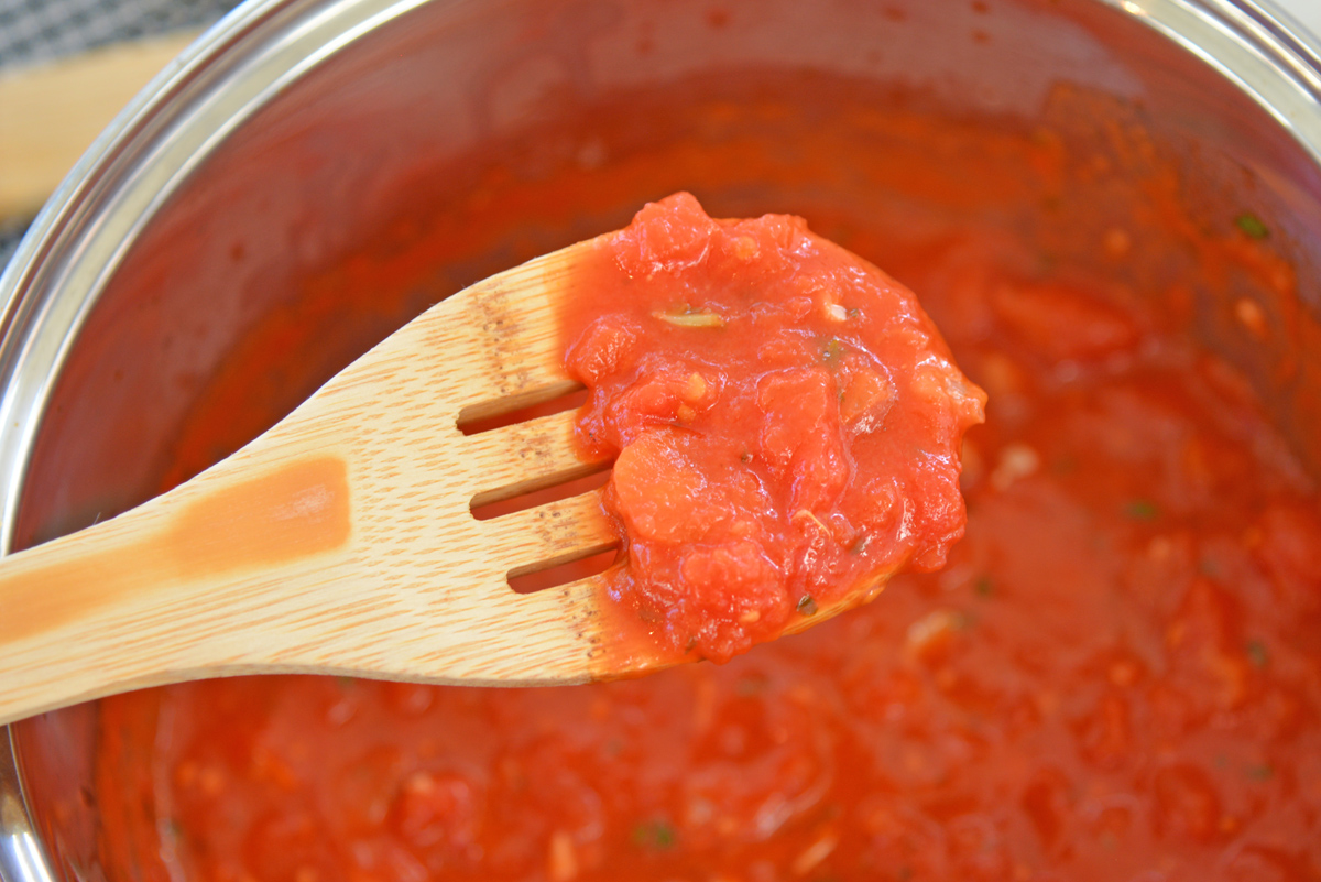 close up of pomodoro sauce on wooden spoon