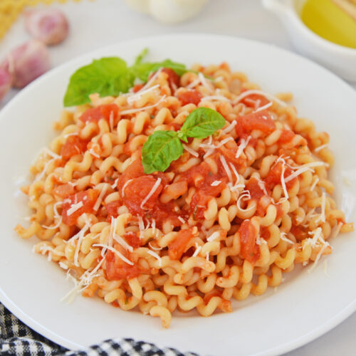 angled shot of bowl of pasta with pomodoro sauce