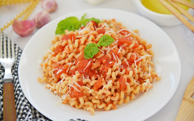 angled shot of bowl of pasta with pomodoro sauce