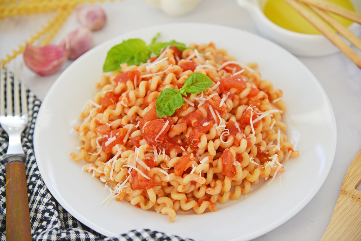 angled shot of bowl of pasta with pomodoro sauce