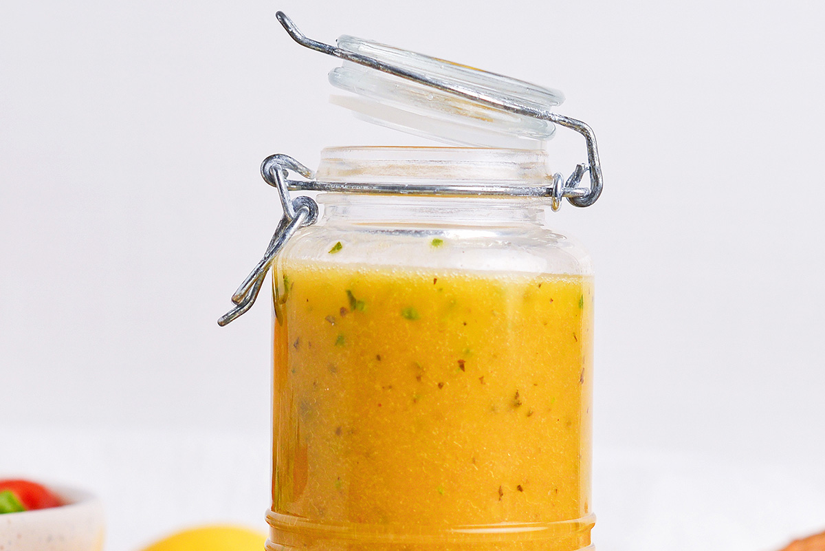 close up straight on shot of greek vinaigrette salad dressing in jar