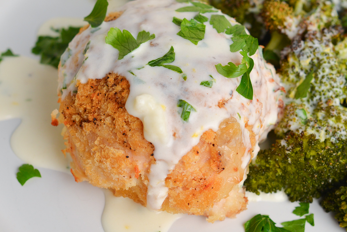 close up angled shot of crispy chicken coated with lemon garlic cream sauce