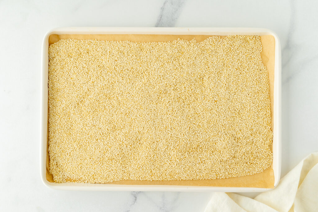 overhead shot of sesame seeds on baking sheet