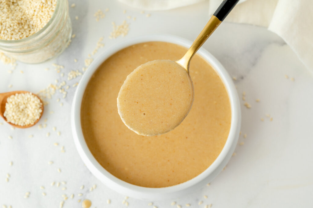 overhead shot of spoon in bowl of tahini