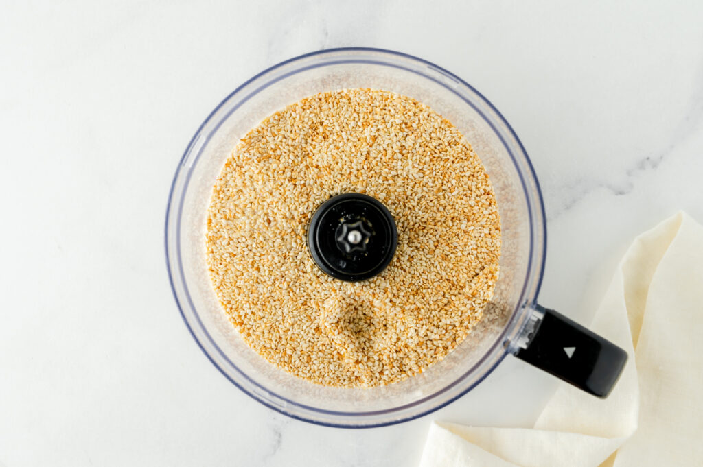 overhead shot of sesame seeds in food processor