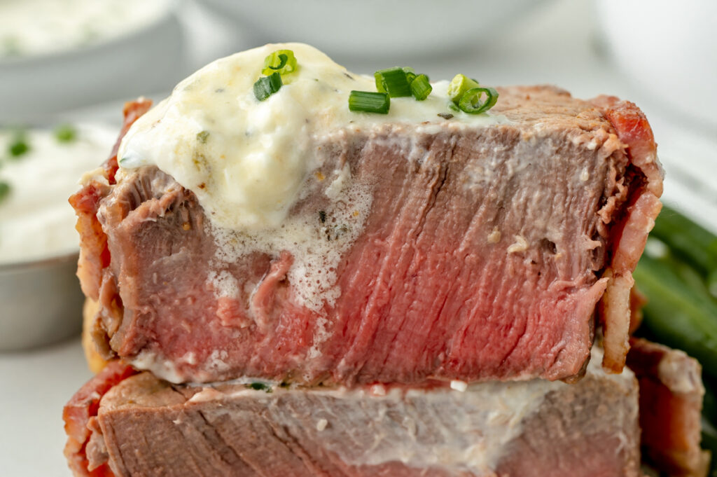 straight on shot of filet cut in half topped with horseradish sauce