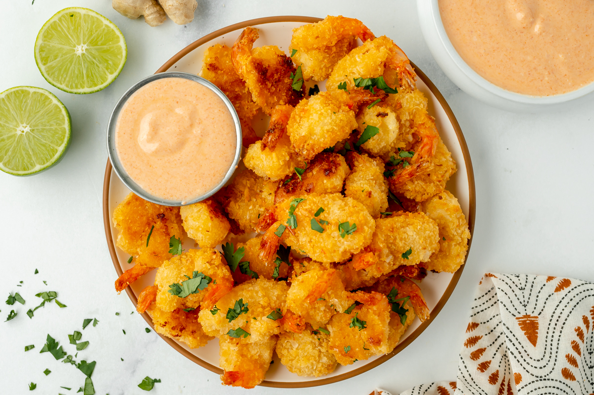 overhead shot of fried shrimp with ramekin of red curry sauce