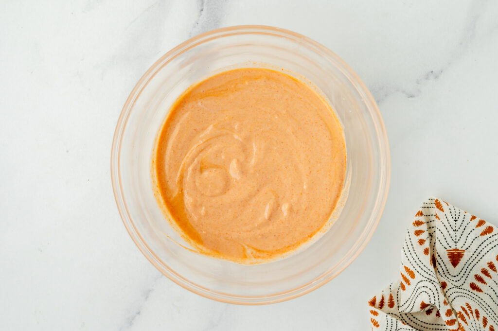 overhead shot of red curry sauce in mixing bowl