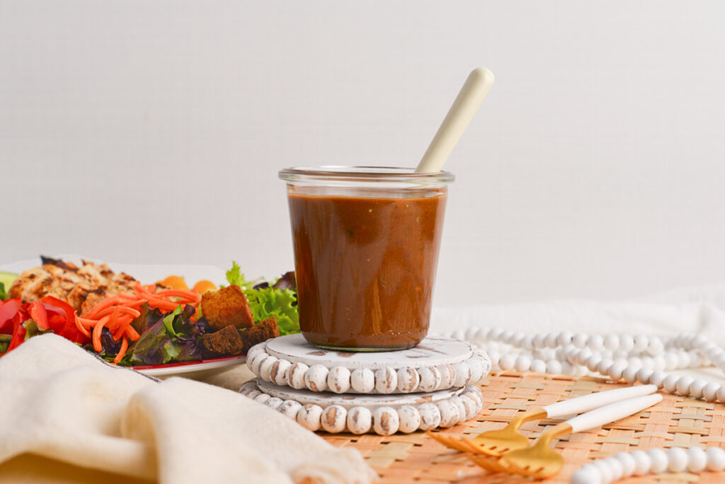 straight on shot of jar of balsamic dressing with spoon in it