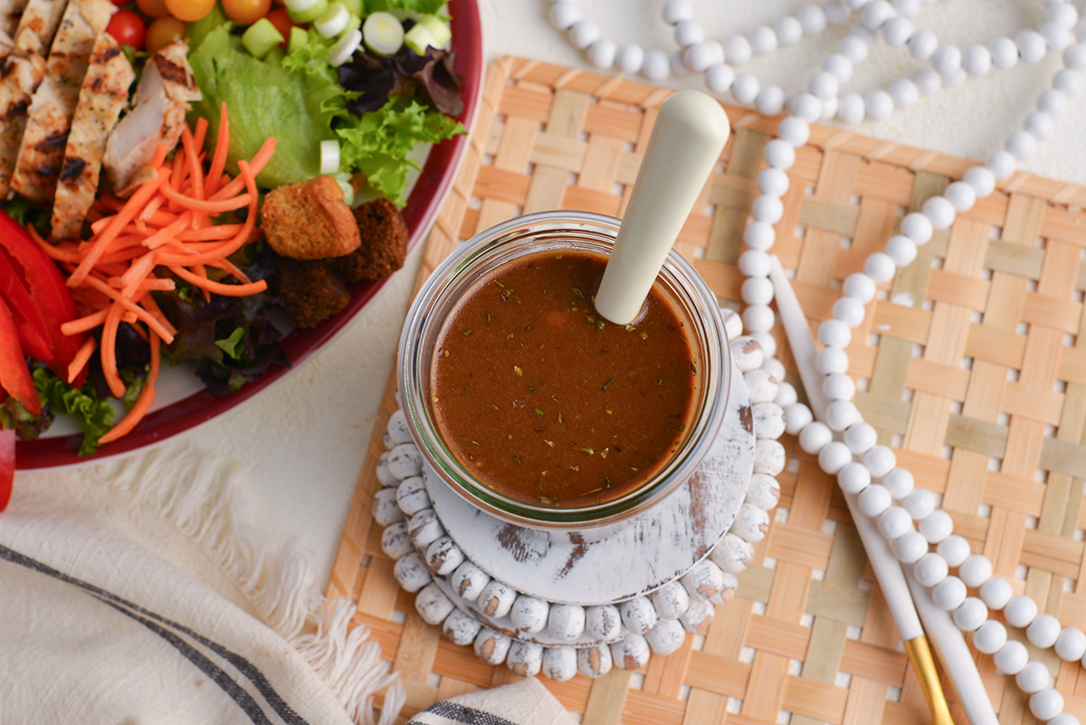 overhead shot of spoon in jar of balsamic dressing