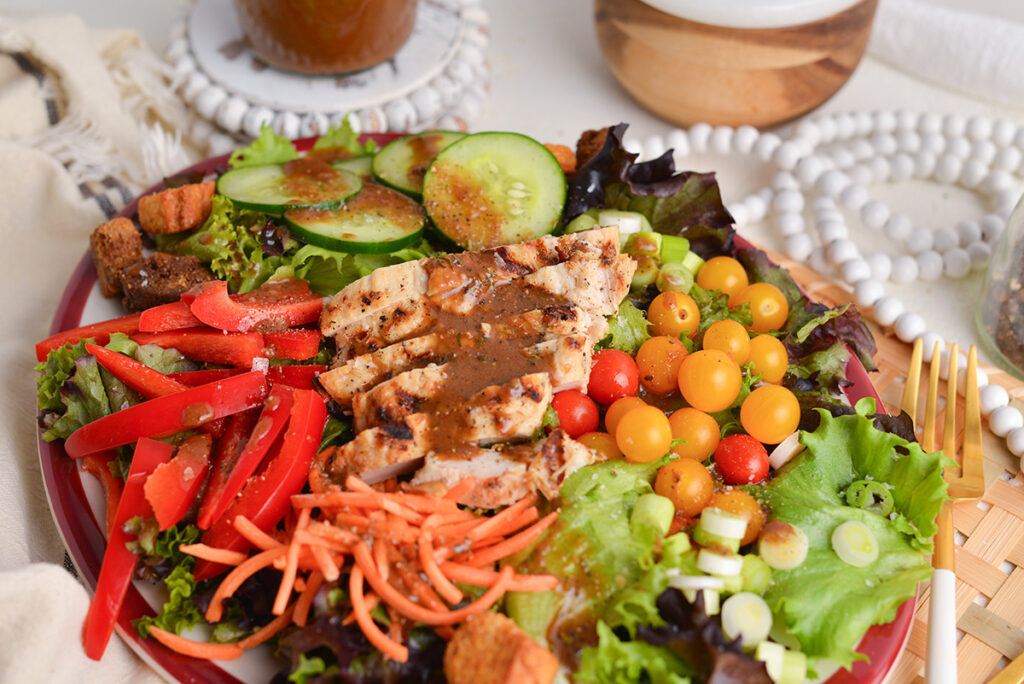 salad and grilled chicken topped with dressing