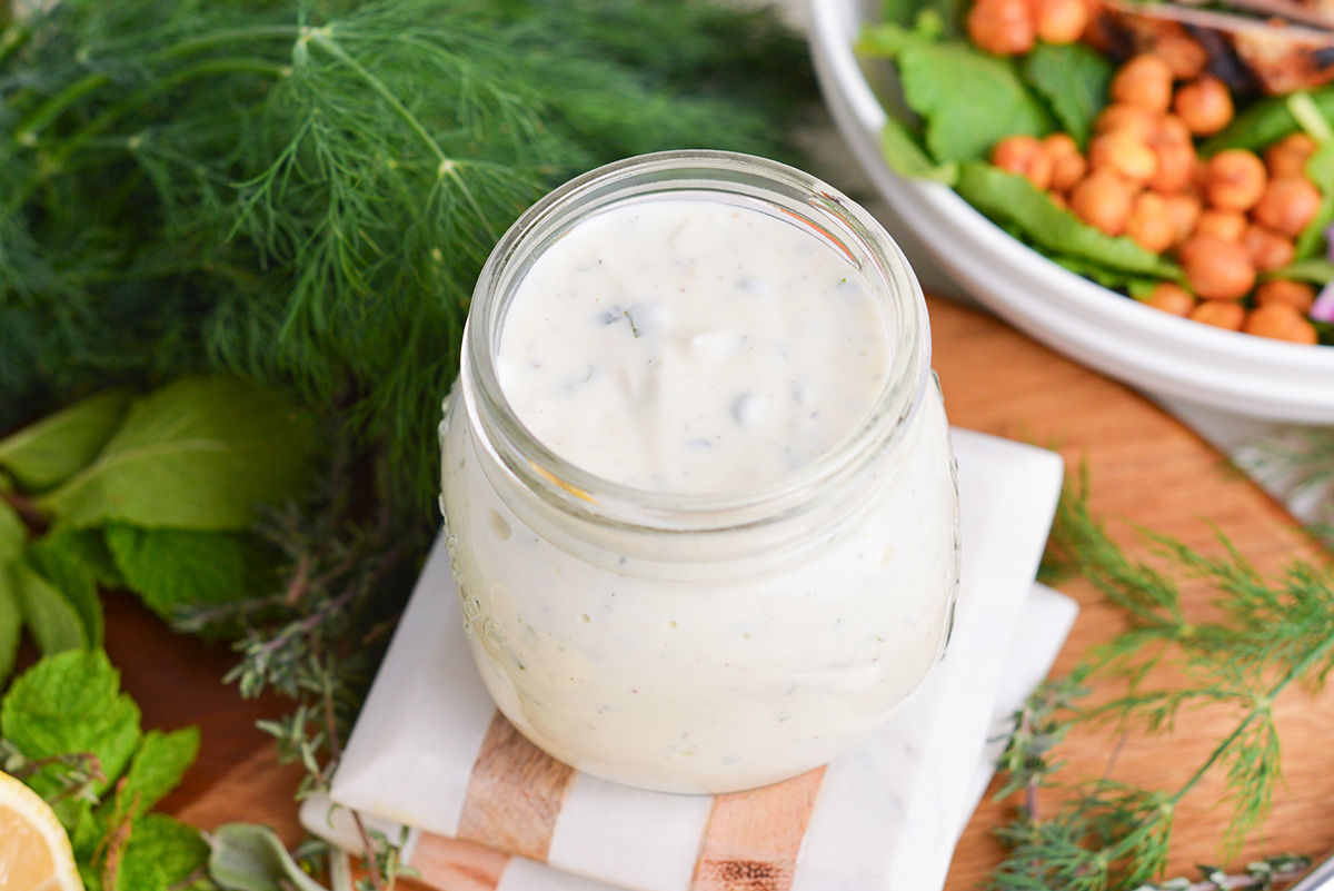 angled shot of jar of creamy greek dressing