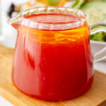 angled shot of salad dressing in jar