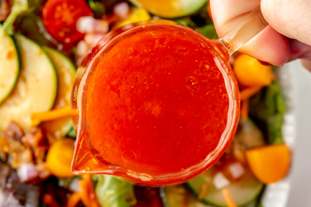 overhead shot of hand holding jar of french dressing