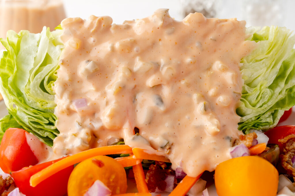 straight on shot of salad topped with thousand island dressing