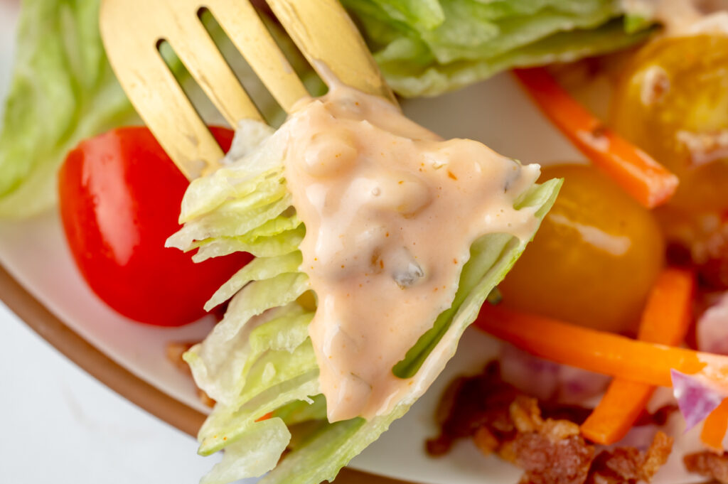 close up of bite of salad coated in dressing