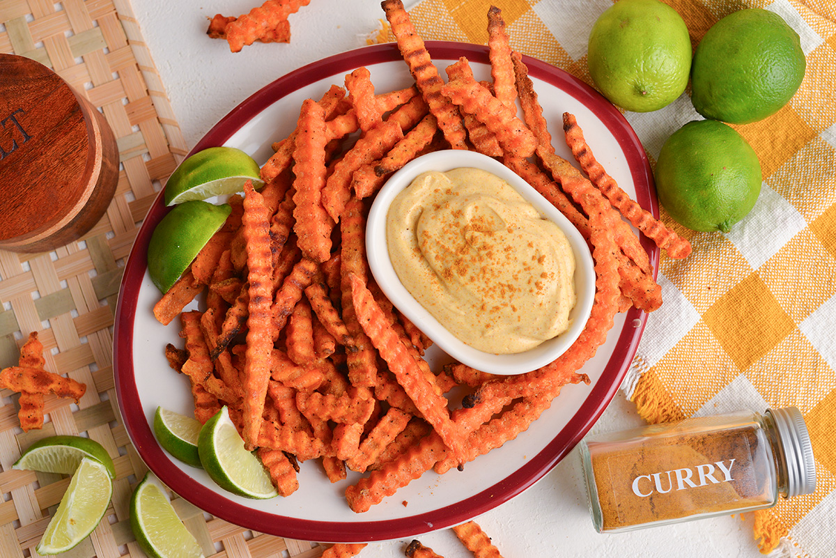 overhead shot of bowl of curry mayo with sweet potato fries