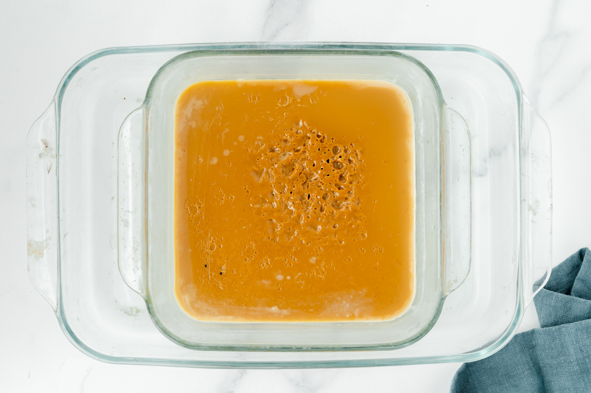 overhead shot of pan of dulce de leche in water bath