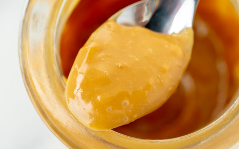 close up shot of spoon full of dulce de leche