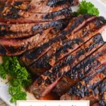 angled shot of sliced london broil on platter with text overlay