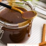 spoon resting on side of jar of gingerbread caramel sauce with text overlay